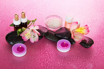 Set of fragrant oils, salt, candles, and flower