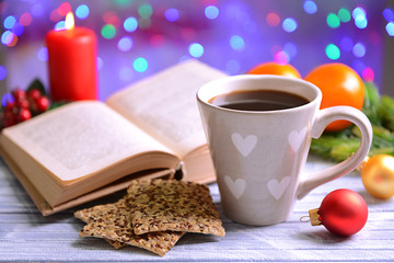 Composition of book with cup of coffee and Christmas