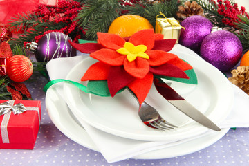 Christmas table setting with festive decorations close up