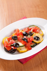 Zucchini salad with tomatoes and olives with bread