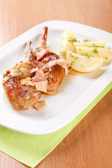 Marinated rabbit with bacon and boiled potatoes
