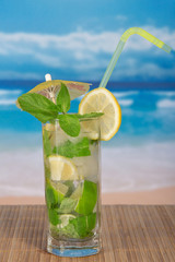 Mojito in a glass on background of the coast