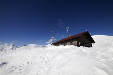 Wooden hotel at snowy mountains