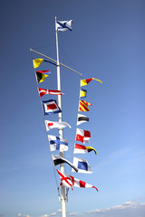 Marine flags of different countries on a mast