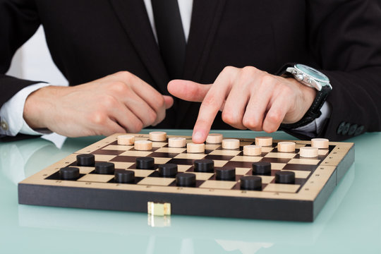 Businessman Playing Checkers