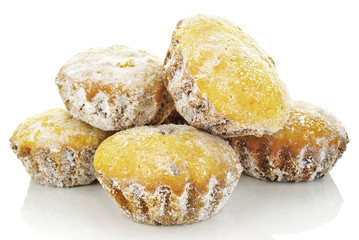 Sweet muffins in powdered sugar isolated on a white background.