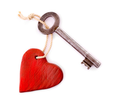 Wooden heart with vintage key isolated