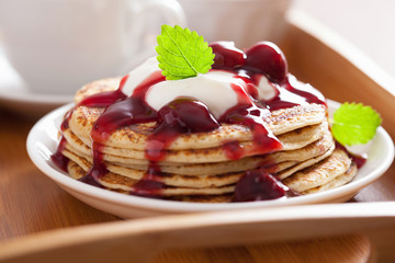 pancakes with cherry jam and cream for breakfast
