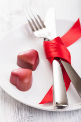 chocolate hearts and silverware on plate for Valentines