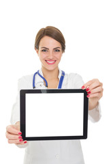 Confident female doctor smiling showing tablet computer