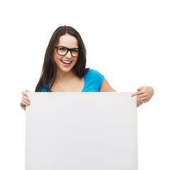 smiling girl with eyeglasses and white blank board
