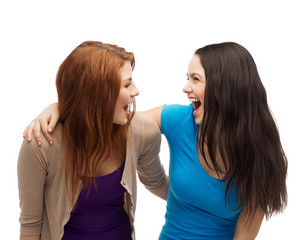 two laughing girls looking at each other
