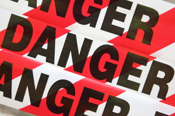Danger tape being used as a sign to warn people