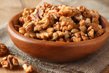 Shelled walnuts on linen fabric background