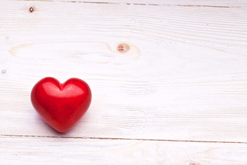 Valentines Day. Red heart on a wooden table.