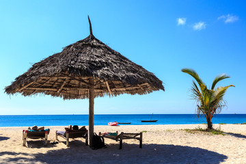 Persons lying on a white sand beach