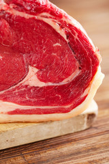 raw beef Rib steak with bone on wooden board and table