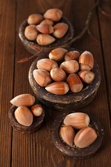 wild hazelnut in iron bowls on wooden table