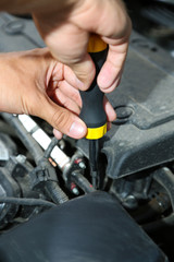Hand with screwdriver. Auto mechanic in car repair