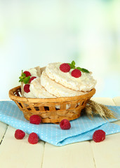 Fototapeta na wymiar Tasty crispbread with berries in wicker basket, on white table