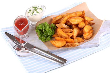 Home potatoes on tracing paper on wooden board isolated on