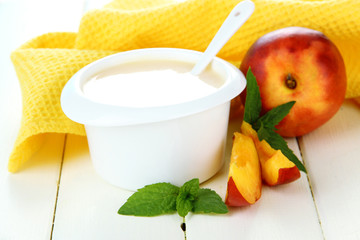 Delicious yogurt with fruit on table close-up