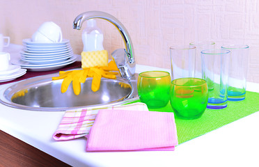 Dishes drying near  metal sink