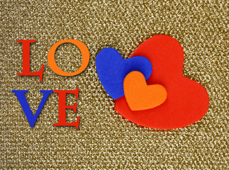 Hearts made of felt on golden background