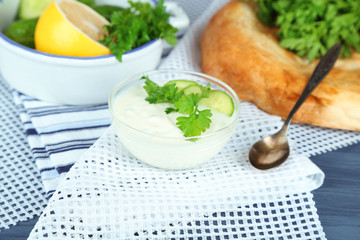 Cucumber yogurt in glass bowl and homemade bread,