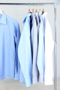 Office male clothes on hangers, on gray background