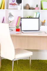 Workplace with laptop, close up