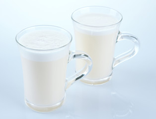 Cups of eggnog isolated on white