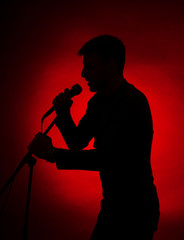 Musician silhouette on dark color background