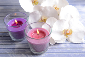 Fototapeta na wymiar Beautiful colorful candles and orchid flowers,