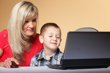 mother with son looking on the laptop