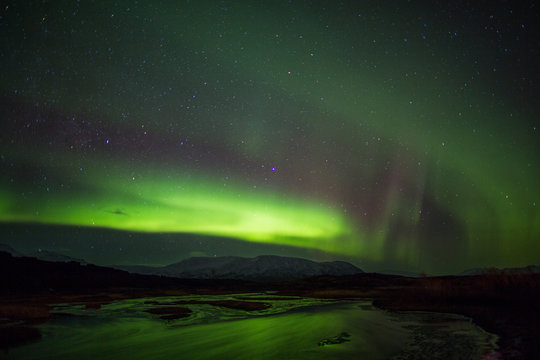Northern Lights above river in Iceland
