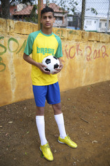 Young Brazilian Football Player Holds Soccer Ball