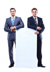 Two smiling business man showing blank signboard,