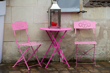 Empty pink table in the cafe during the rain