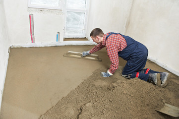 Plasterer concrete worker at floor work