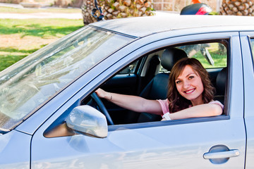 young and beautiful woman driving a car