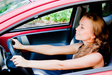 young and beautiful woman driving a car