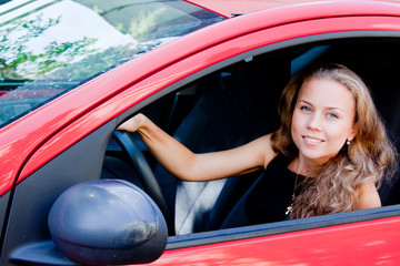 young and beautiful woman driving a car