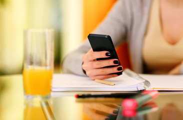 Closeup image of a woman hand holding smartphone