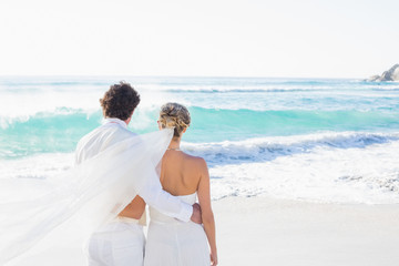 Newlyweds looking out to sea together