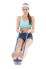 Fit woman exercising with a blue yoga belt