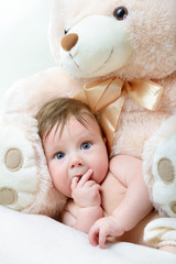 cute funny infant baby boy with big toy bear, beautiful kid's po