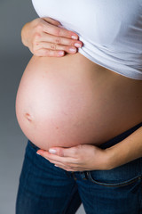 Pregnant woman isolated on white