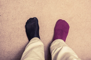 Feet with odd socks on  carpet