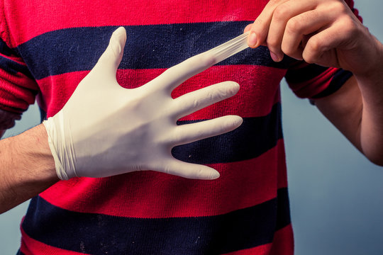 Man removing latex glove